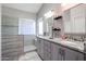 Elegant bathroom with double sinks, granite countertops, and a walk-in shower at 26028 N 66Th Dr, Phoenix, AZ 85083