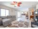 Open living room with a view of the kitchen and staircase, featuring tile floors and a ceiling fan at 26028 N 66Th Dr, Phoenix, AZ 85083