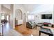 Spacious living room with hardwood floors, large TV, and comfy furniture at 26028 N 66Th Dr, Phoenix, AZ 85083