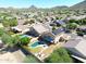 Aerial view of a house featuring a private pool and solar panels in a residential area with mountains at 26028 N 66Th Dr, Phoenix, AZ 85083
