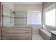 Large walk-in shower with tiled walls and built-in seat at 26028 N 66Th Dr, Phoenix, AZ 85083