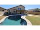 Inviting kidney-shaped pool with patio furniture and spacious backyard at 26028 N 66Th Dr, Phoenix, AZ 85083