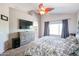 Main bedroom with large bed, dresser, and en-suite bathroom at 26028 N 66Th Dr, Phoenix, AZ 85083
