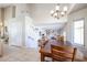 Bright dining area with chandelier and view to living room at 26028 N 66Th Dr, Phoenix, AZ 85083