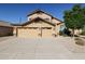 Two-story house with tan exterior, two-car garage, and landscaped yard at 26028 N 66Th Dr, Phoenix, AZ 85083