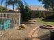 Large backyard with fire pit, patio, and grassy area at 18527 W Caribbean Ln, Surprise, AZ 85388