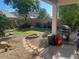 Landscaped backyard with fire pit and flagstone path at 18527 W Caribbean Ln, Surprise, AZ 85388