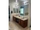 Bathroom with double sinks, large mirror, and separate shower and tub at 18527 W Caribbean Ln, Surprise, AZ 85388