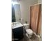Modern bathroom with dark vanity, updated toilet and shower at 18527 W Caribbean Ln, Surprise, AZ 85388