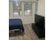 Well-lit bedroom with tile floors and ample space for furniture at 18527 W Caribbean Ln, Surprise, AZ 85388