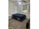 Cozy bedroom with tile floor and a full-size bed at 18527 W Caribbean Ln, Surprise, AZ 85388