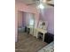Bedroom featuring a vanity, mirrored closet, and gray flooring at 18527 W Caribbean Ln, Surprise, AZ 85388