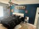 Bedroom with dark-colored walls and a king-size bed at 18527 W Caribbean Ln, Surprise, AZ 85388