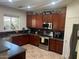 Spacious kitchen featuring dark wood cabinets and stainless steel appliances at 18527 W Caribbean Ln, Surprise, AZ 85388