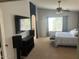 Main bedroom with large bed, TV, and ensuite bathroom access at 18527 W Caribbean Ln, Surprise, AZ 85388