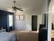 Main bedroom with large bed and access to a second room at 18527 W Caribbean Ln, Surprise, AZ 85388
