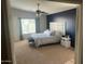 Main bedroom with large bed and ensuite bathroom access at 18527 W Caribbean Ln, Surprise, AZ 85388