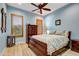Bedroom with light blue walls and wood flooring at 3129 S Honeysuckle Ct, Gold Canyon, AZ 85118
