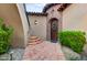 Inviting entryway with terracotta tile flooring, arched entry, and lush landscaping at 3129 S Honeysuckle Ct, Gold Canyon, AZ 85118