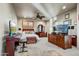 Spacious bedroom with a king-size bed, built-in desk, and large TV at 3129 S Honeysuckle Ct, Gold Canyon, AZ 85118