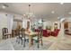Elegant dining room with a farmhouse table, chandelier, and view into living room at 3129 S Honeysuckle Ct, Gold Canyon, AZ 85118