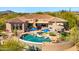 Beautiful backyard with a pool, waterfall, and covered patio at 34617 N Desert Ridge Dr, Scottsdale, AZ 85262