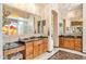 Bathroom with double vanity, granite countertop, and stained glass window at 34617 N Desert Ridge Dr, Scottsdale, AZ 85262
