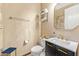 Powder room with a vanity featuring dark wood cabinets, white countertop, and brass faucet at 34617 N Desert Ridge Dr, Scottsdale, AZ 85262
