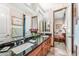 Bathroom featuring double sinks, granite countertops, and a large mirror at 34617 N Desert Ridge Dr, Scottsdale, AZ 85262