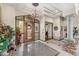 Grand foyer with tile floors, chandelier, and decorative column at 34617 N Desert Ridge Dr, Scottsdale, AZ 85262
