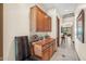 Hallway with wooden cabinets and tile flooring leading to another room at 34617 N Desert Ridge Dr, Scottsdale, AZ 85262