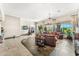 Living room with leather furniture, fireplace, tile floors, and large windows at 34617 N Desert Ridge Dr, Scottsdale, AZ 85262