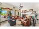 Another view of the living room with a fireplace, leather furniture, and large windows at 34617 N Desert Ridge Dr, Scottsdale, AZ 85262