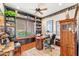 Home office with built-in shelves, window seat, and wood flooring at 34617 N Desert Ridge Dr, Scottsdale, AZ 85262