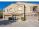 Three-car garage and two-story tan home with stone accents at 4777 S Fulton Ranch Blvd # 2071, Chandler, AZ 85248