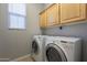 Laundry room with washer, dryer, and wood cabinets at 4777 S Fulton Ranch Blvd # 2071, Chandler, AZ 85248