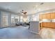 Open living room with kitchen, balcony access, and lots of natural light at 4777 S Fulton Ranch Blvd # 2071, Chandler, AZ 85248