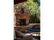 Stone outdoor fireplace with wood mantle at 1547 W Vernon Ave, Phoenix, AZ 85007