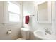 Clean bathroom with white fixtures and a window at 1547 W Vernon Ave, Phoenix, AZ 85007