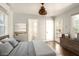 Main bedroom with hardwood floors and access to a bathroom and backyard at 1547 W Vernon Ave, Phoenix, AZ 85007
