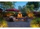 Relaxing patio with fire pit, seating area, and umbrella at 1547 W Vernon Ave, Phoenix, AZ 85007