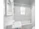Clean bathroom with bathtub, pedestal sink, and window at 1547 W Vernon Ave, Phoenix, AZ 85007