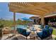 Spacious patio with pergola, comfortable seating, and stunning views at 34617 N Desert Ridge Dr, Scottsdale, AZ 85262