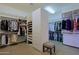 Spacious walk-in closet with custom shelving and drawers at 34617 N Desert Ridge Dr, Scottsdale, AZ 85262