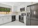 Modern kitchen with stainless steel appliances and white cabinets at 9214 W Kerry Ln, Peoria, AZ 85382