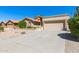 Single-story home with desert landscaping and a two-car garage at 9214 W Kerry Ln, Peoria, AZ 85382