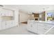 Island kitchen with white cabinets, quartz countertops and stainless steel appliances at 9214 W Kerry Ln, Peoria, AZ 85382