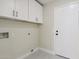 Bright laundry room with white cabinets and built-in storage at 9214 W Kerry Ln, Peoria, AZ 85382
