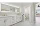 Modern bathroom with double vanity and access to a powder room at 9214 W Kerry Ln, Peoria, AZ 85382