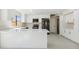 Spacious kitchen with white cabinets, quartz countertops, and stainless steel appliances at 9214 W Kerry Ln, Peoria, AZ 85382